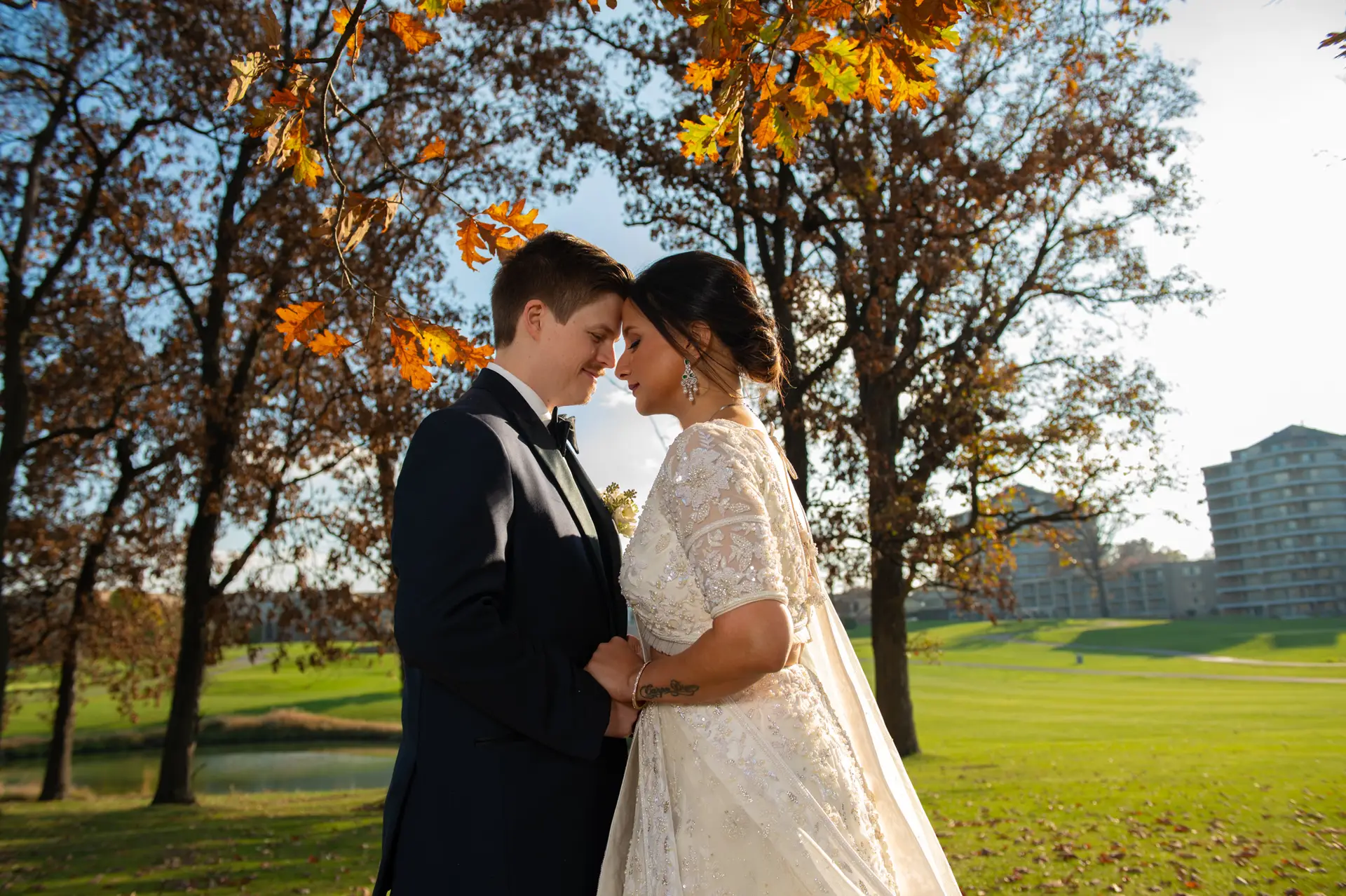 bride-groom-under-fall-trees-at-eaglewood-resort-and-spa-itasca-illinois